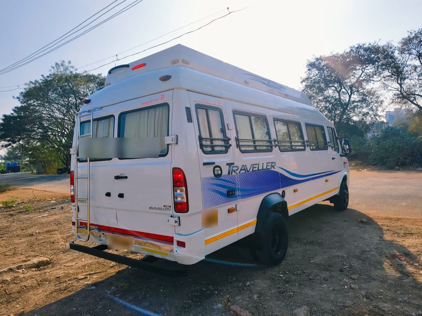 A white Force Traveller seen from behind, parked on an open road